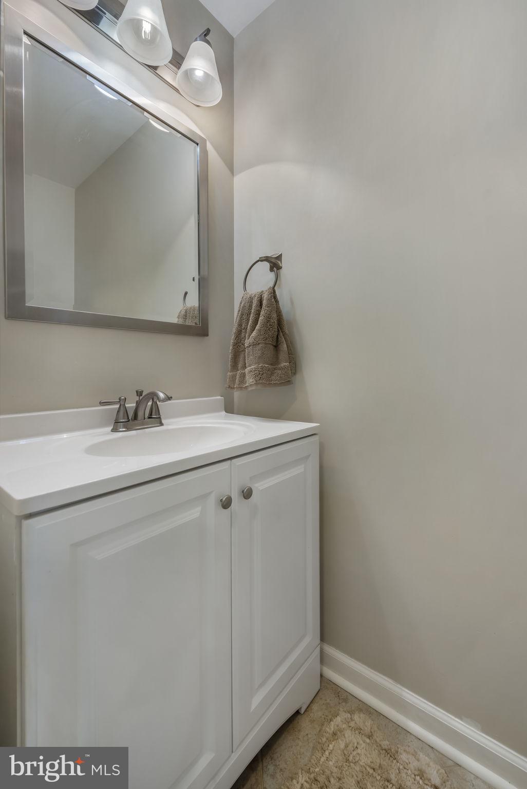 8504 Silverdale Road Lorton, VA 22079 - Photo 21 of 48 a bathroom with a sink vanity and mirror