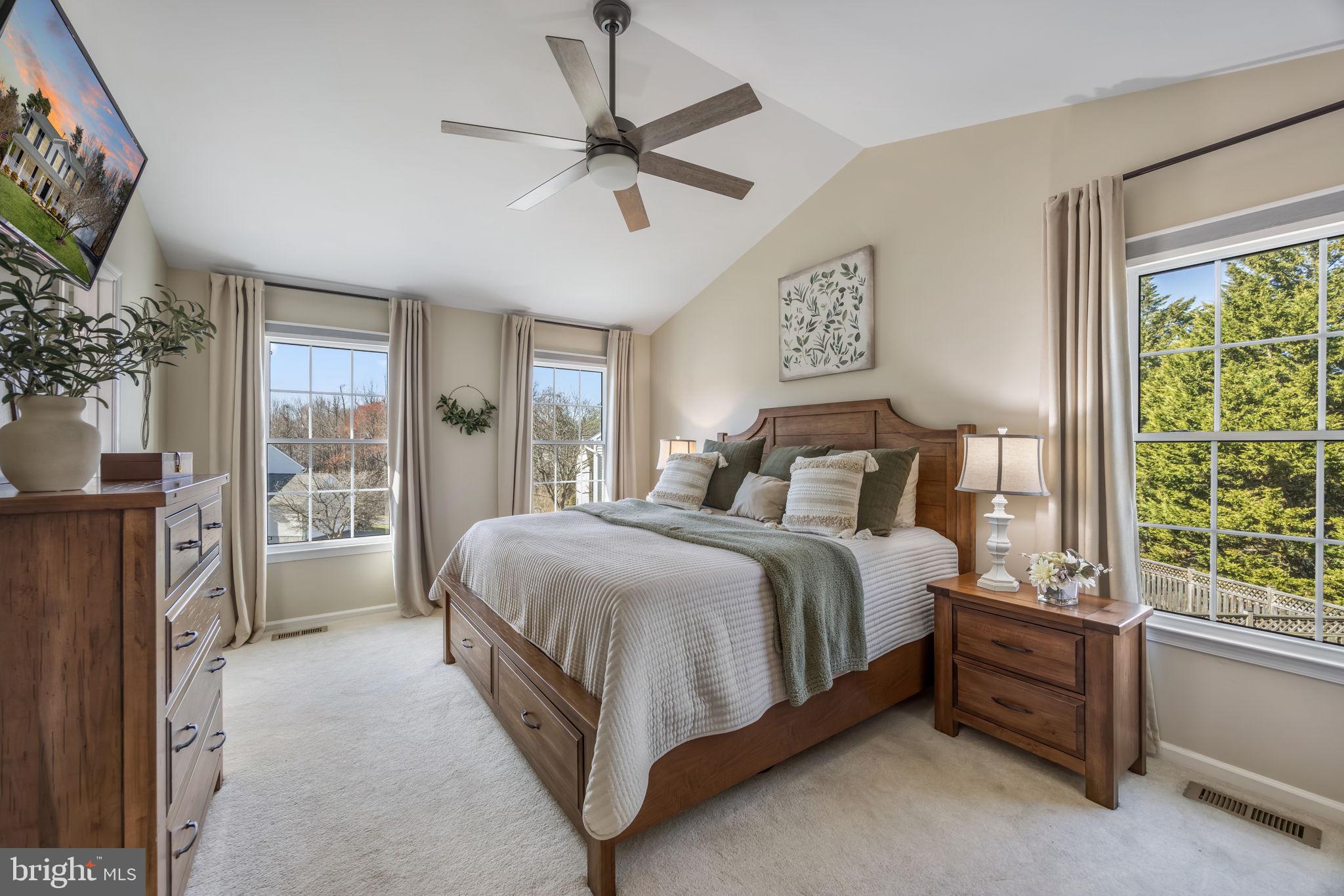 8504 Silverdale Road Lorton, VA 22079 - Photo 22 of 48 a bedroom with a large bed and a chandelier fan