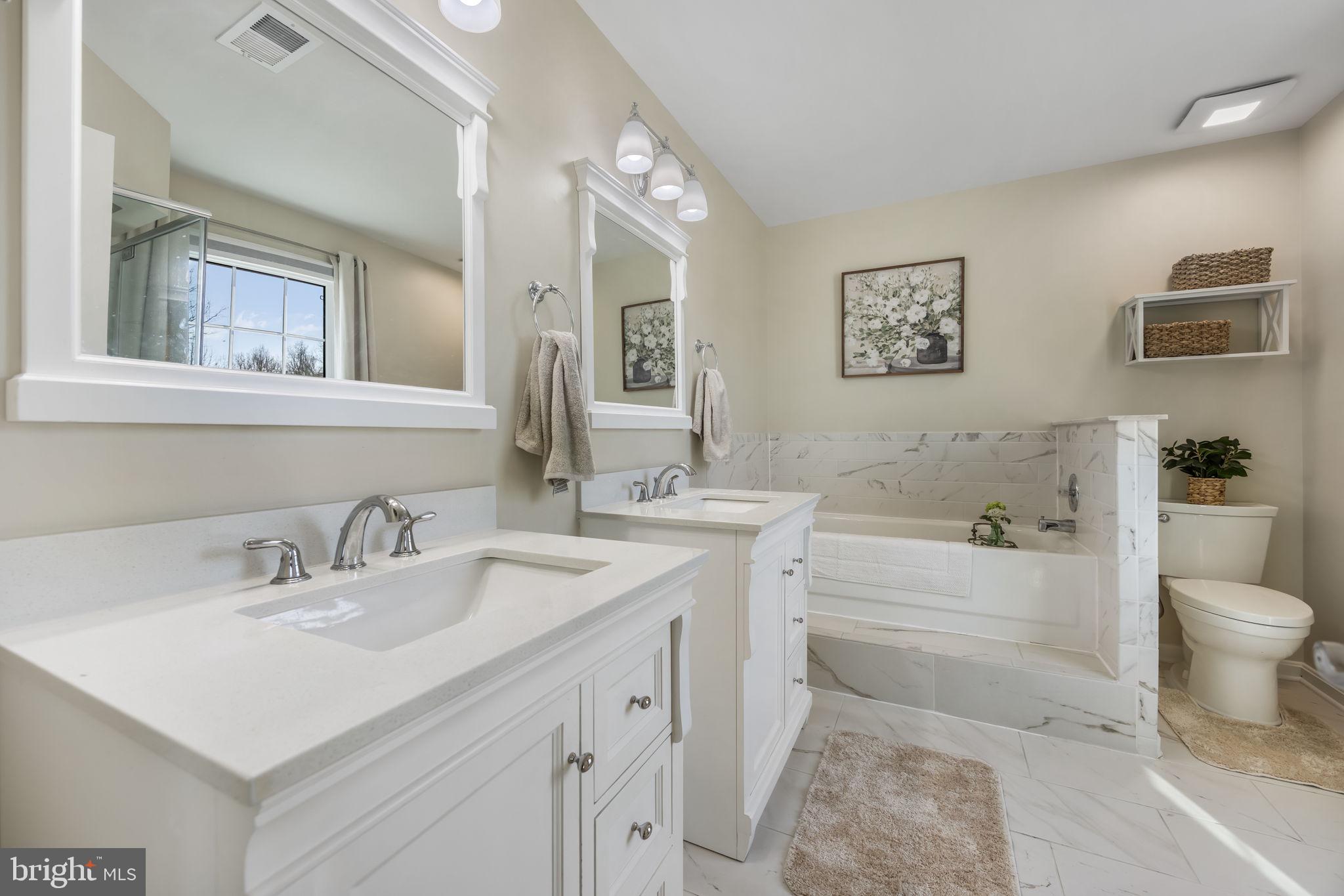 8504 Silverdale Road Lorton, VA 22079 - Photo 26 of 48 a bathroom with a sink toilet vanity and tub