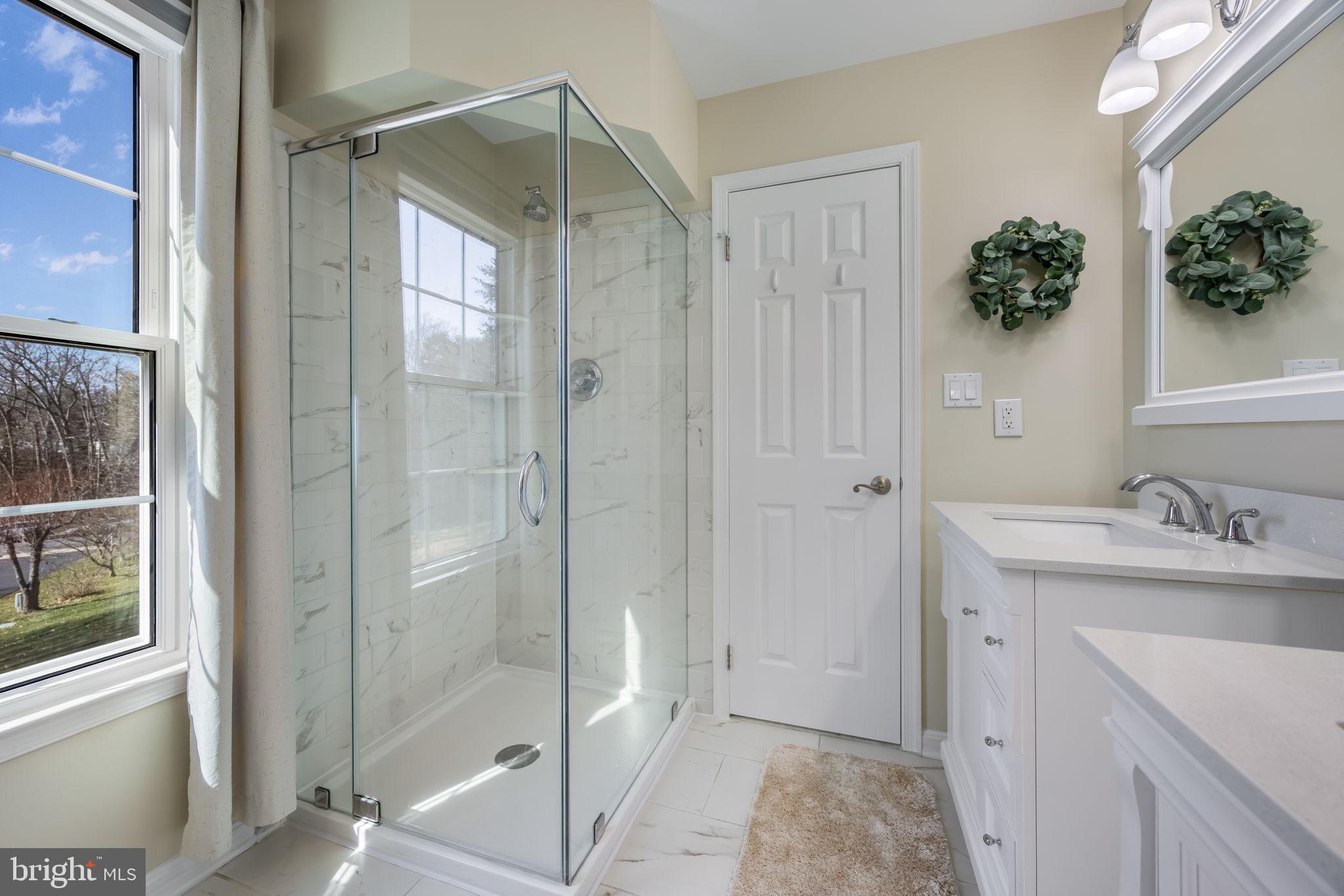 8504 Silverdale Road Lorton, VA 22079 - Photo 27 of 48 a bathroom with a shower sink and mirror