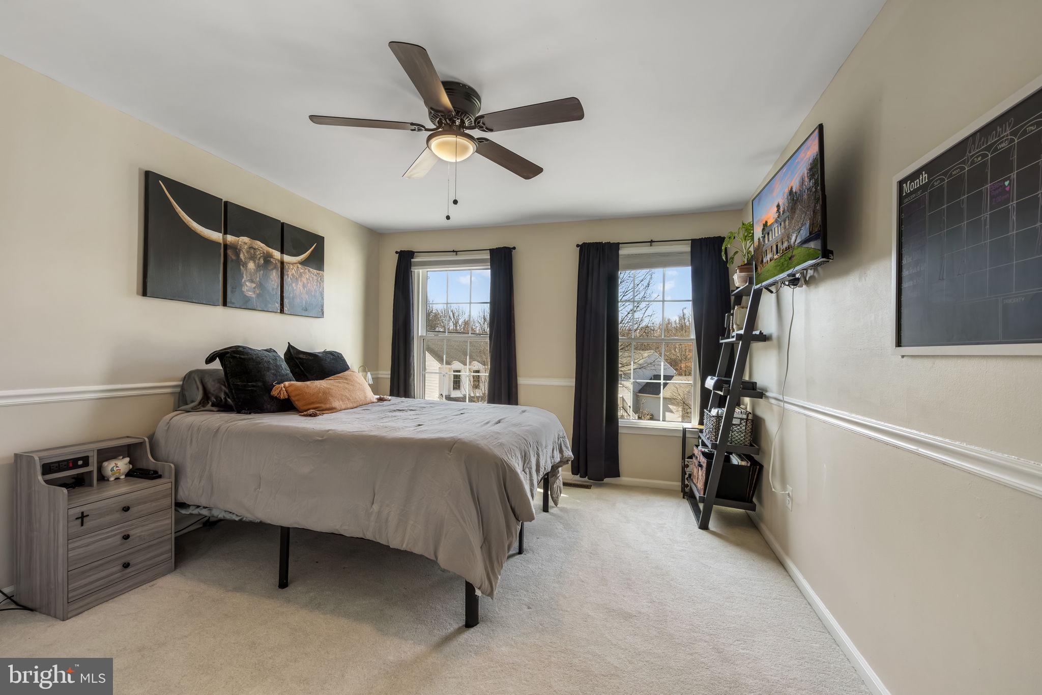 8504 Silverdale Road Lorton, VA 22079 - Photo 29 of 48 a bedroom with a bed and a chandelier