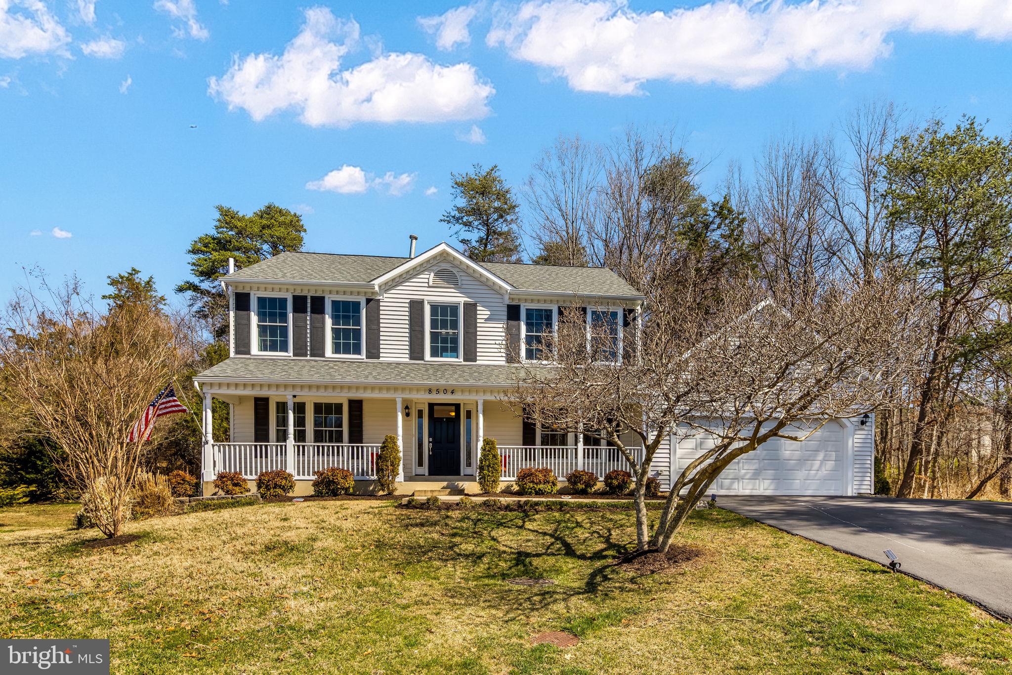 8504 Silverdale Road Lorton, VA 22079 - Photo 3 of 48 a view of a white house with a yard patio and fire pit