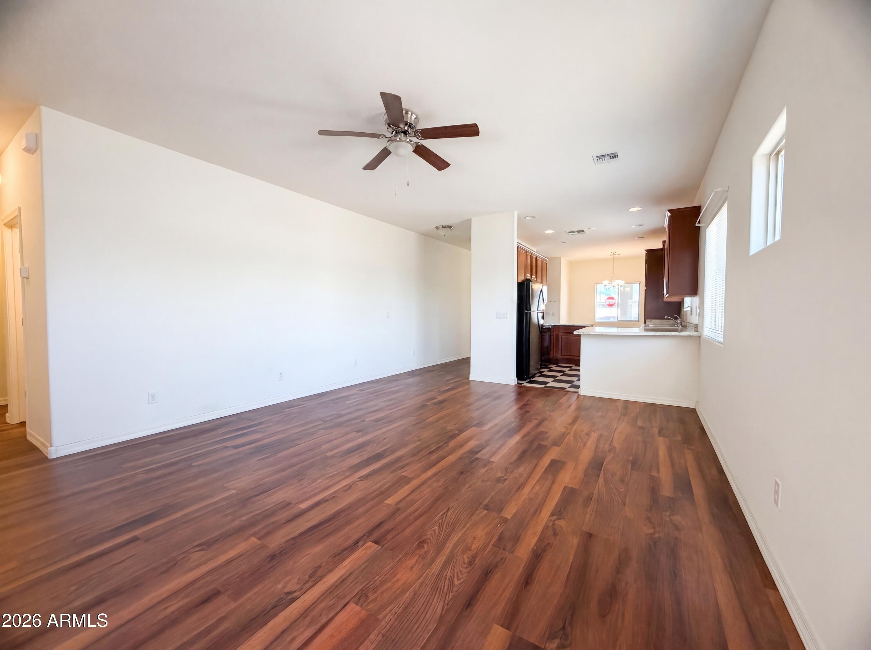 1738 South Aryelle Road Apache Junction, AZ 85119 - Photo 8 of 17 an empty room with wooden floor and windows