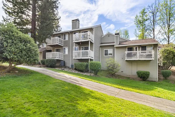 a view of a house with a yard and plants
