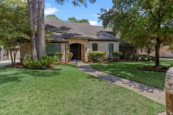 a front view of house with yard and green space