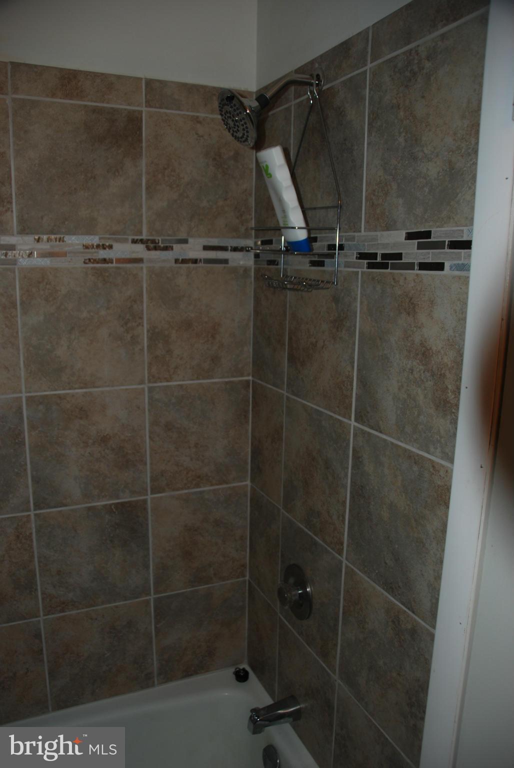 11019 Saffold Way Reston, VA 20190 - Photo 11 of 22 a bathroom with a glass shower door
