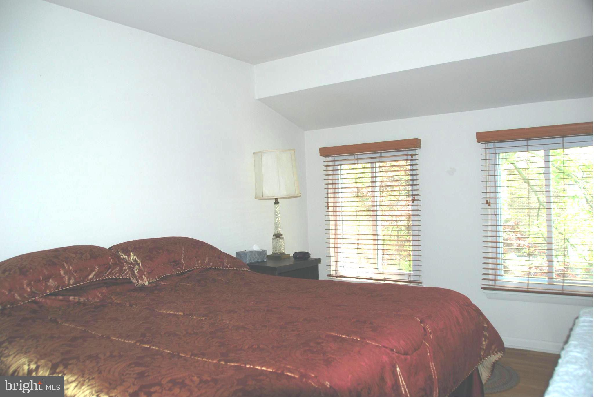11019 Saffold Way Reston, VA 20190 - Photo 12 of 22 a bedroom with a bed window and a lamp