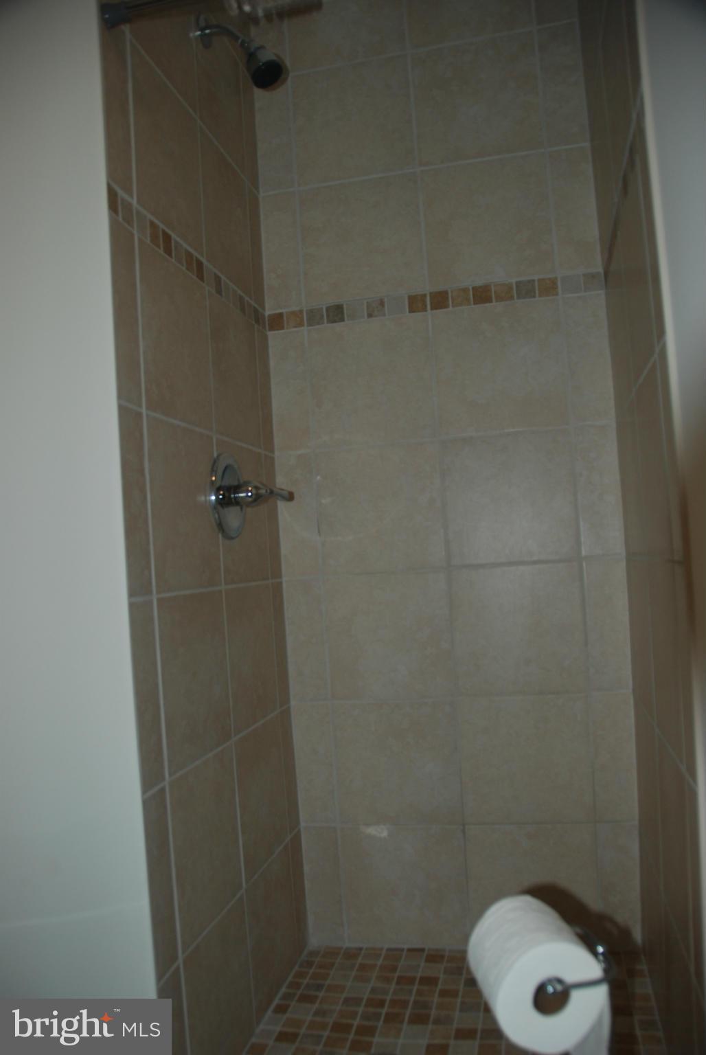 11019 Saffold Way Reston, VA 20190 - Photo 18 of 22 a bathroom with a toilet and a shower