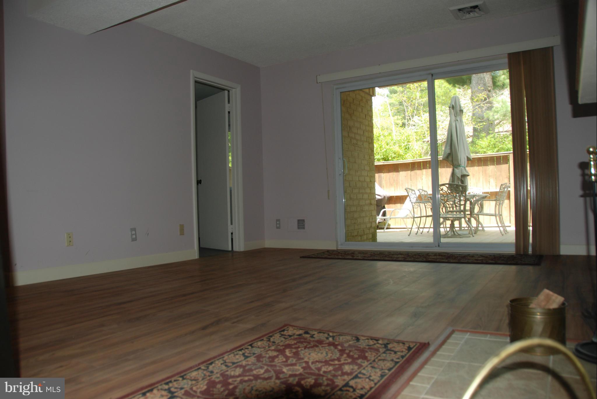 11019 Saffold Way Reston, VA 20190 - Photo 20 of 22 a view of an empty room with wooden floor and a window