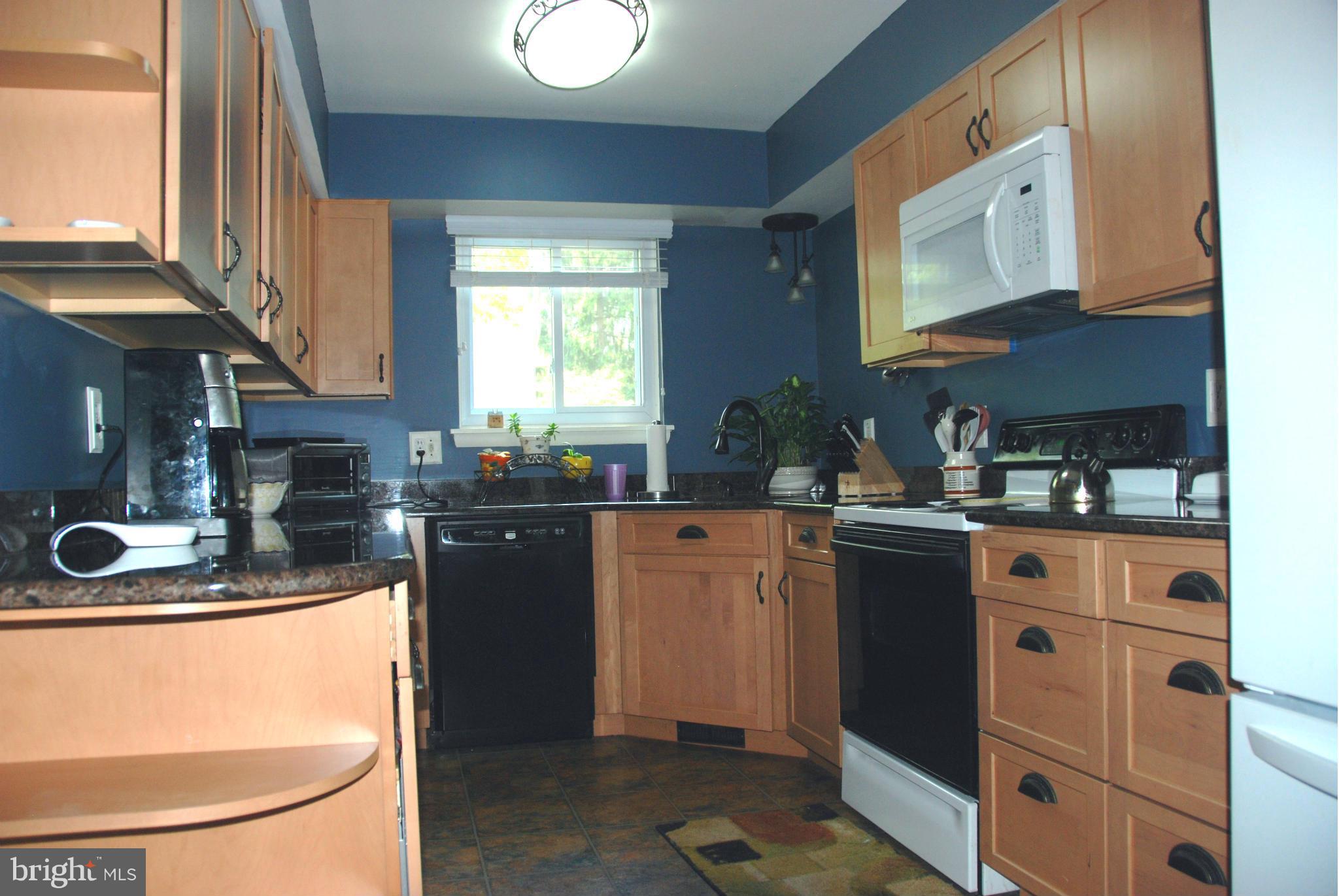 11019 Saffold Way Reston, VA 20190 - Photo 3 of 22 a kitchen with stainless steel appliances granite countertop a sink stove and cabinets