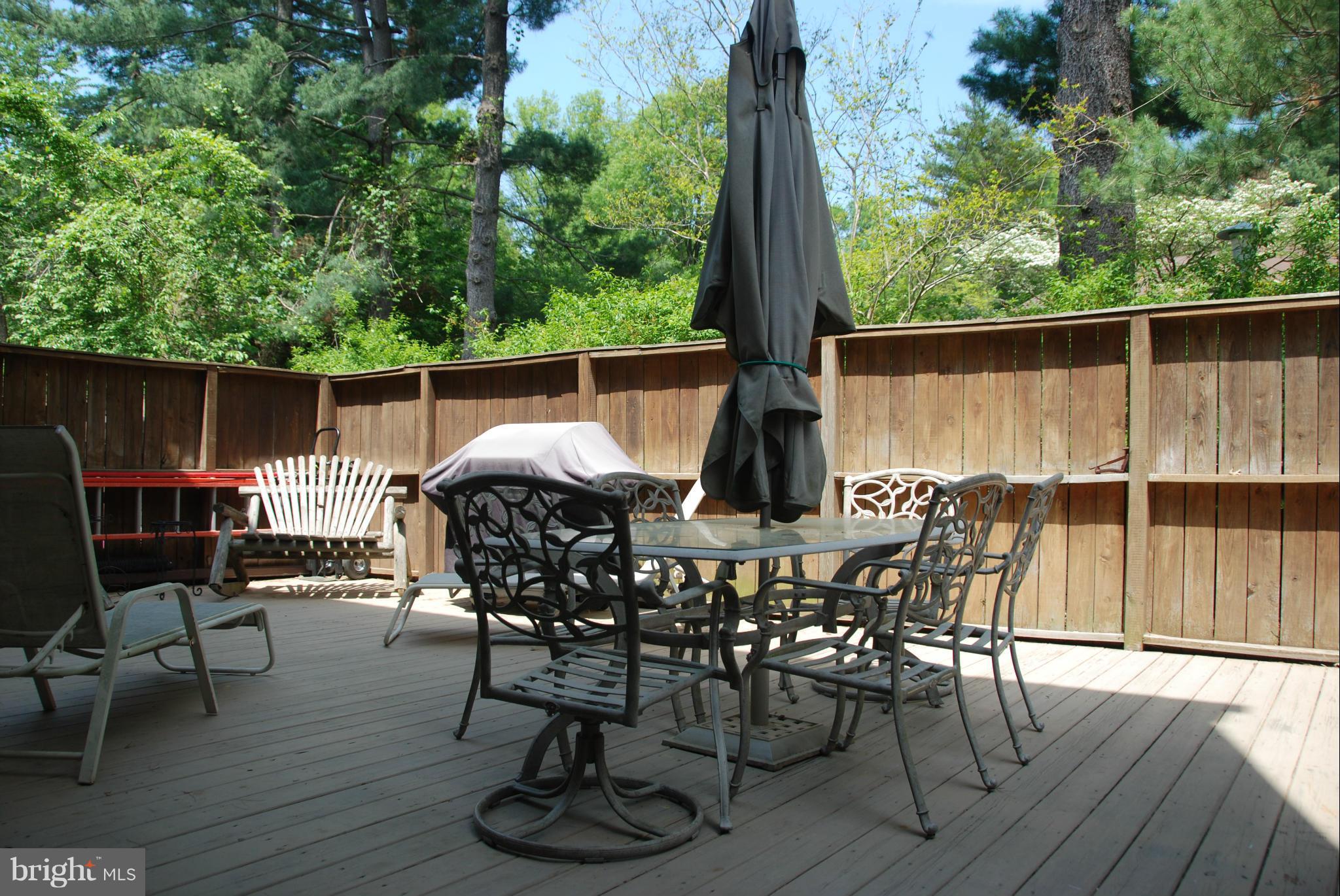 11019 Saffold Way Reston, VA 20190 - Photo 21 of 22 a view of a patio with table and chairs a barbeque with wooden floor and fence