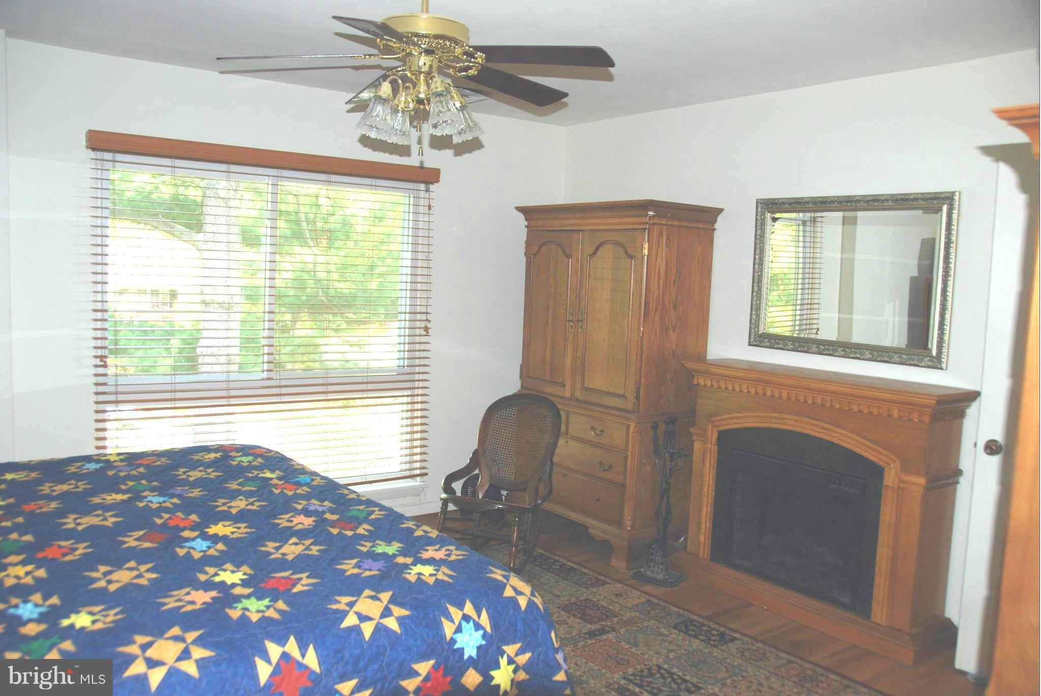 11019 Saffold Way Reston, VA 20190 - Photo 7 of 22 a bedroom with a bed and a chair