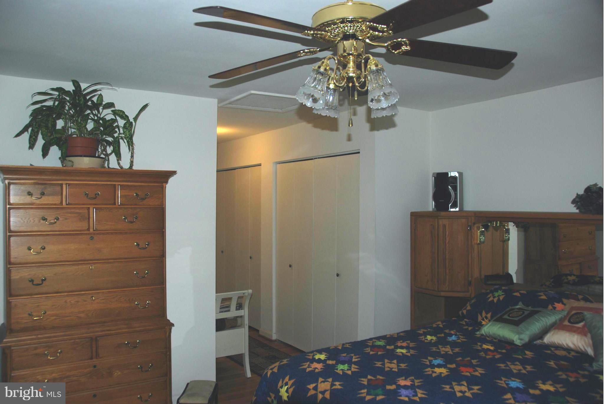 11019 Saffold Way Reston, VA 20190 - Photo 8 of 22 a bedroom with a bed and a chandelier fan