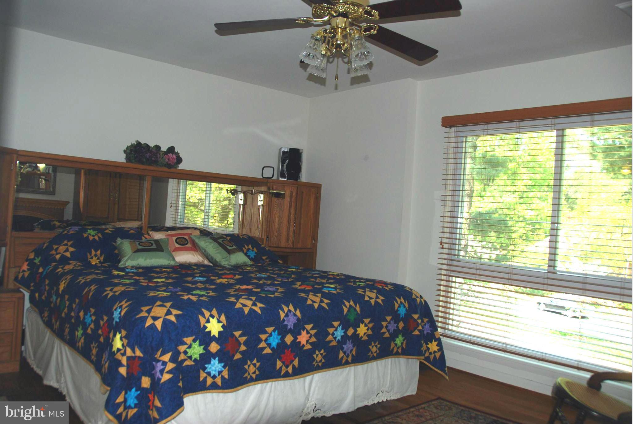 11019 Saffold Way Reston, VA 20190 - Photo 9 of 22 a bedroom with a large bed and a chandelier