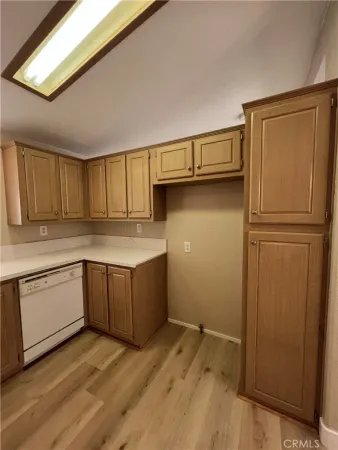 a kitchen with a refrigerator sink and cabinets