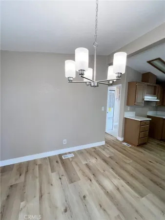 a view of a kitchen with microwave and cabinets