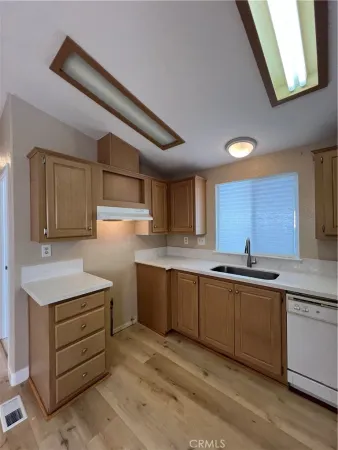 a kitchen that has a sink and a stove in it