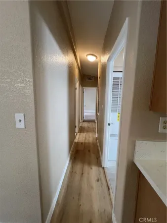 a view of hallway with wooden floor