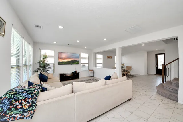 a living room with furniture and a large window
