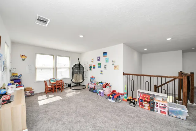 a room with toys and a dining table with wooden floor