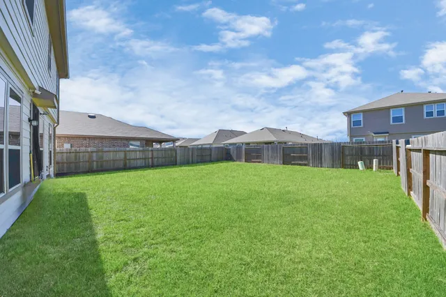 a view of house with backyard