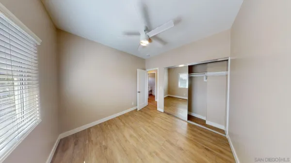 a view of hallway with stairs and wooden floor