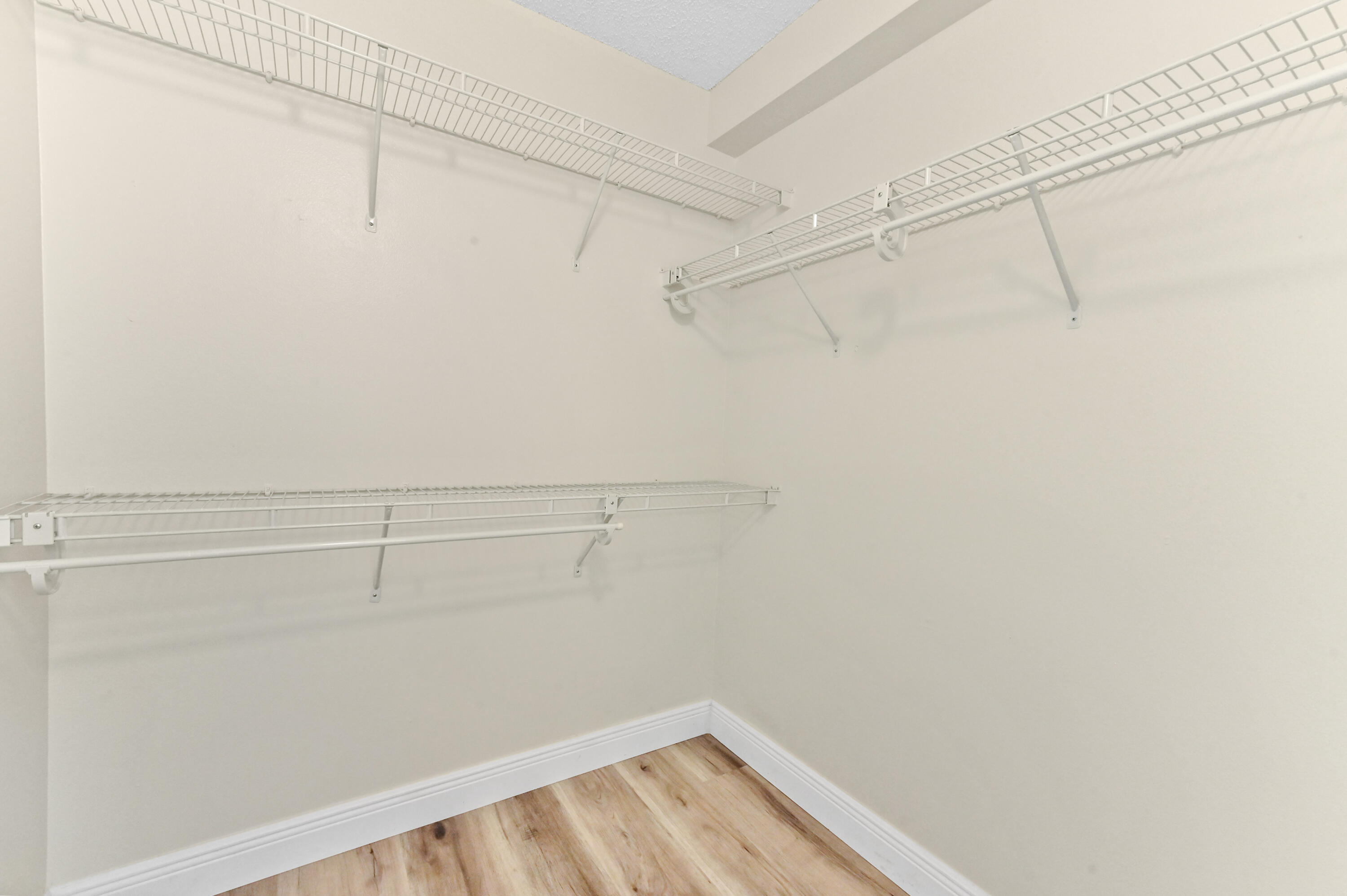 3237 Clint Moore Road, Unit 107 Boca Raton, FL 33496 - Photo 20 of 41 a view of a room with racks on the wall