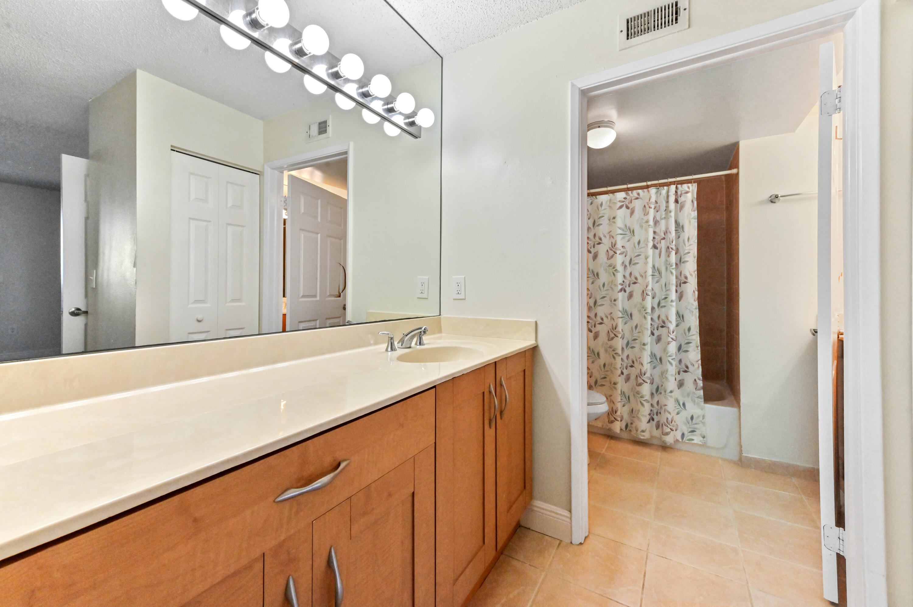 3237 Clint Moore Road, Unit 107 Boca Raton, FL 33496 - Photo 21 of 41 a bathroom with a sink and a mirror