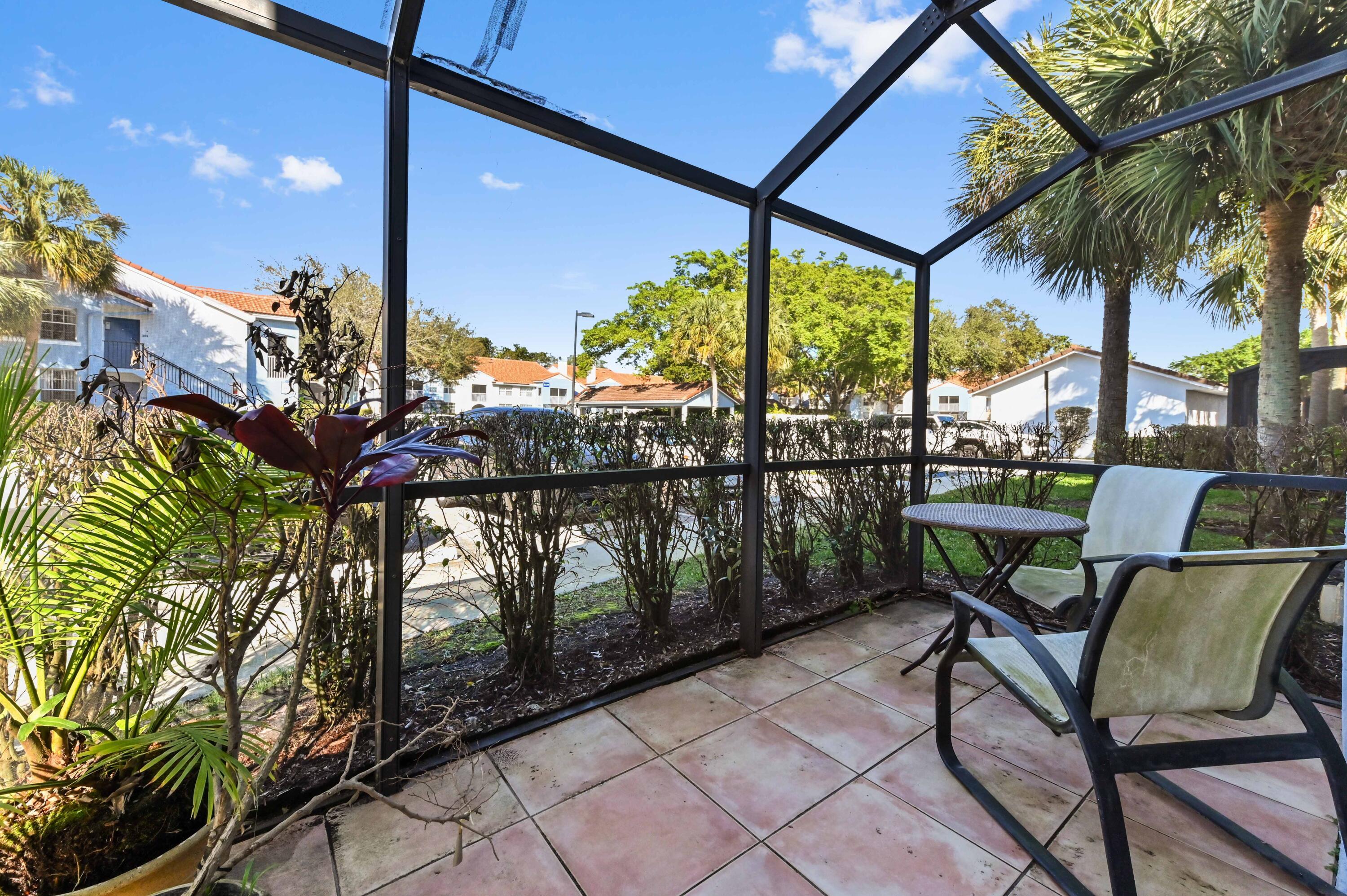 3237 Clint Moore Road, Unit 107 Boca Raton, FL 33496 - Photo 24 of 41 a view of a chairs and table in the patio