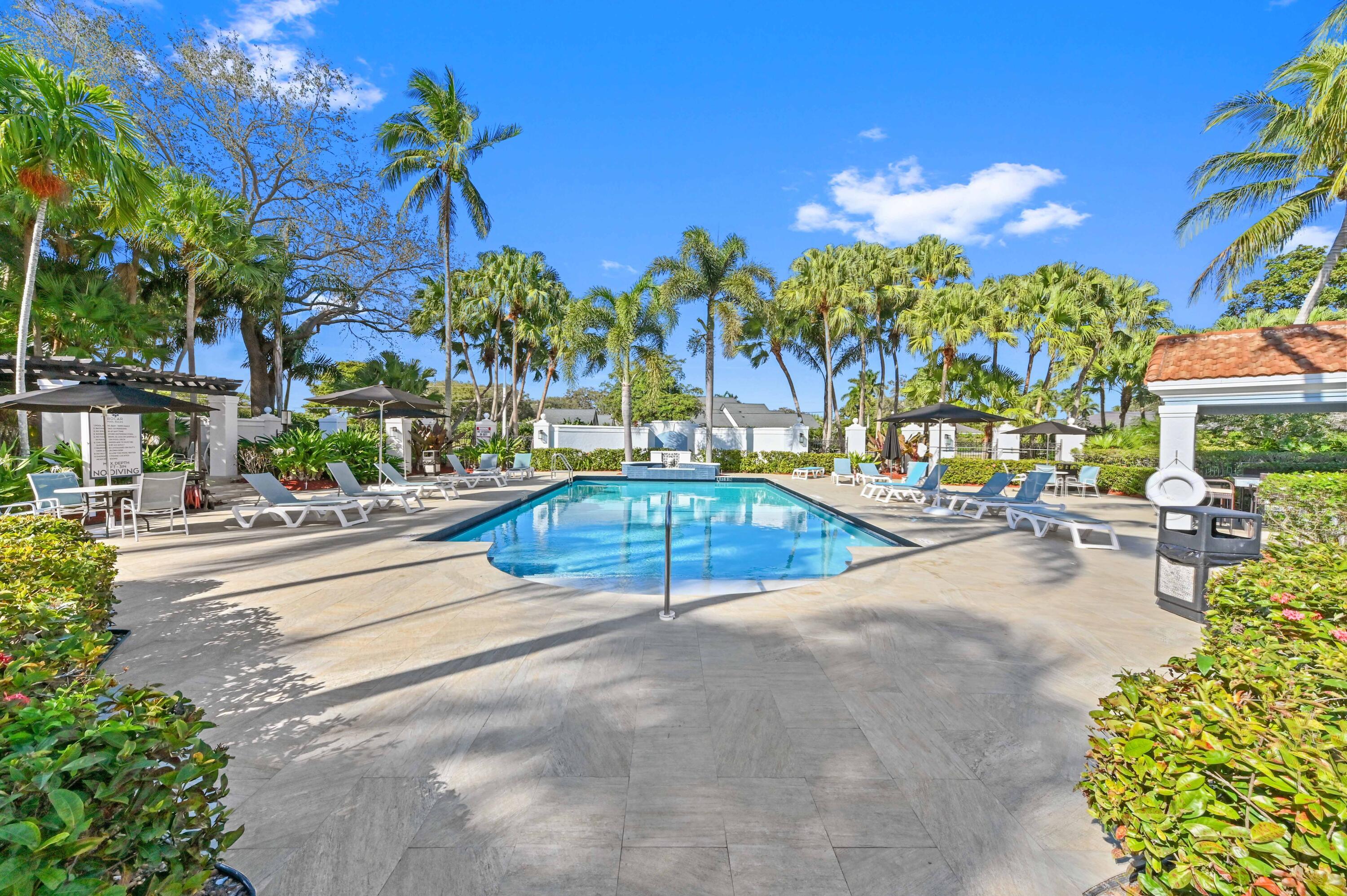 3237 Clint Moore Road, Unit 107 Boca Raton, FL 33496 - Photo 27 of 41 a view of a swimming pool with a patio