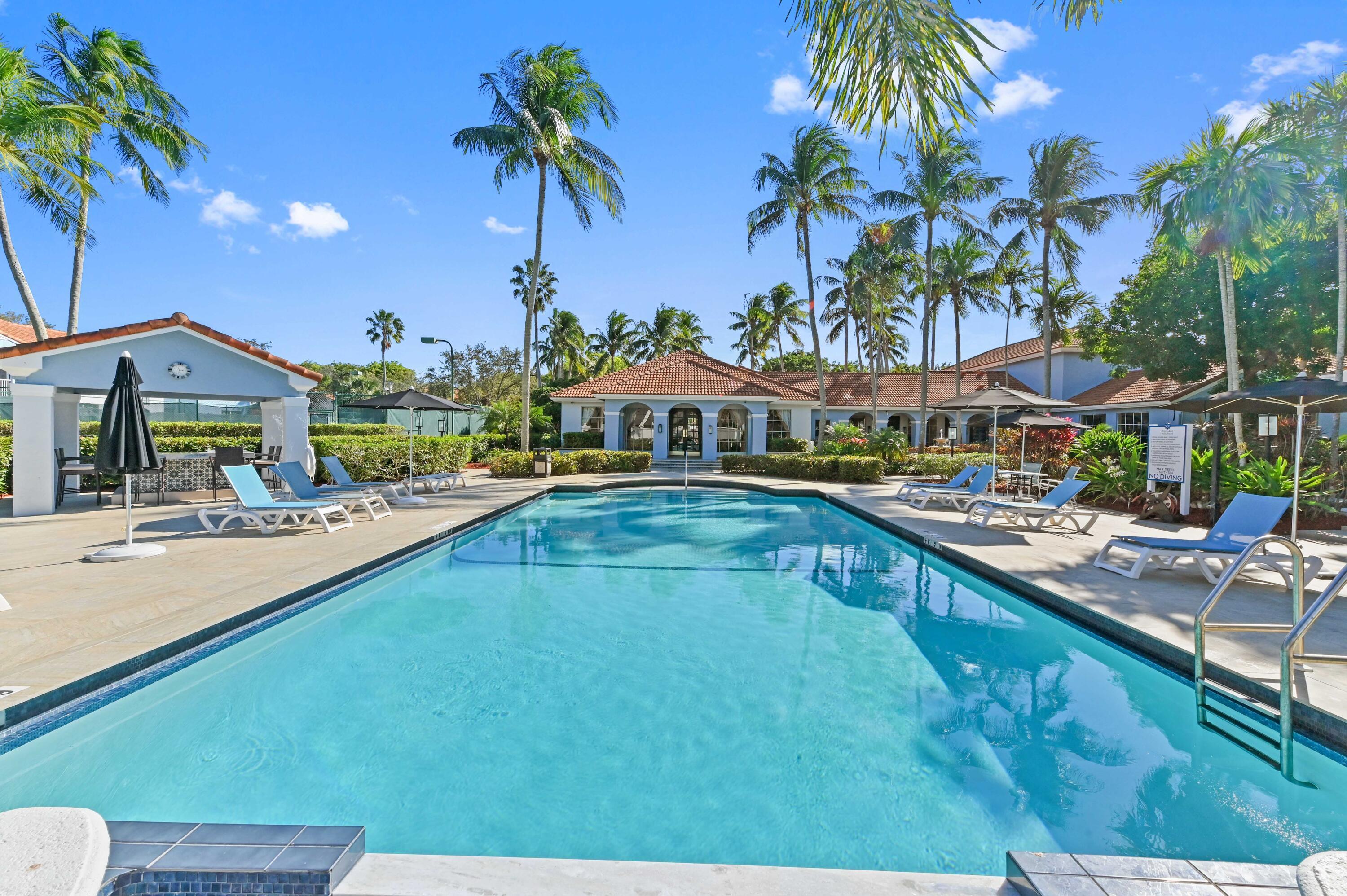 3237 Clint Moore Road, Unit 107 Boca Raton, FL 33496 - Photo 28 of 41 a swimming pool view with a seating space and a garden