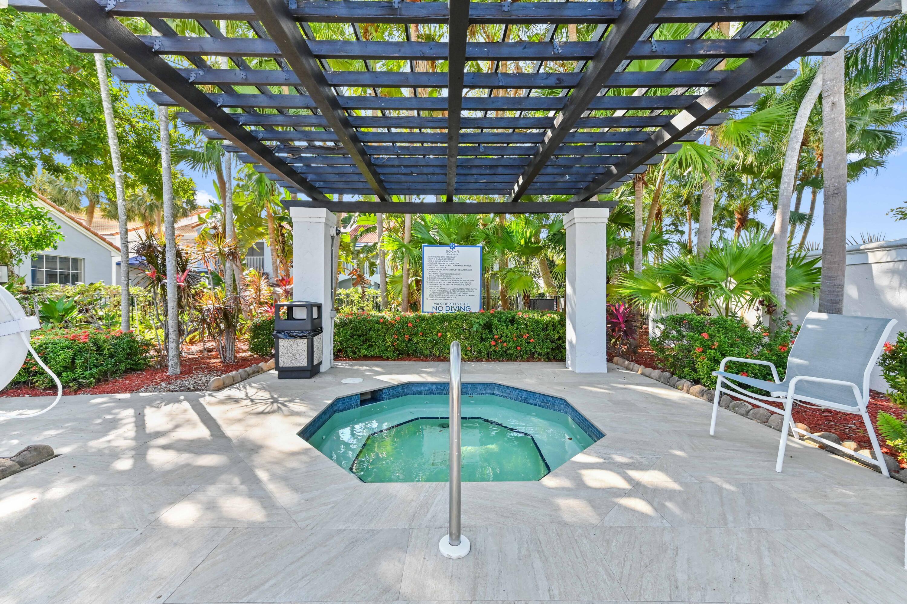 3237 Clint Moore Road, Unit 107 Boca Raton, FL 33496 - Photo 30 of 41 a backyard with table and chairs with potted plants