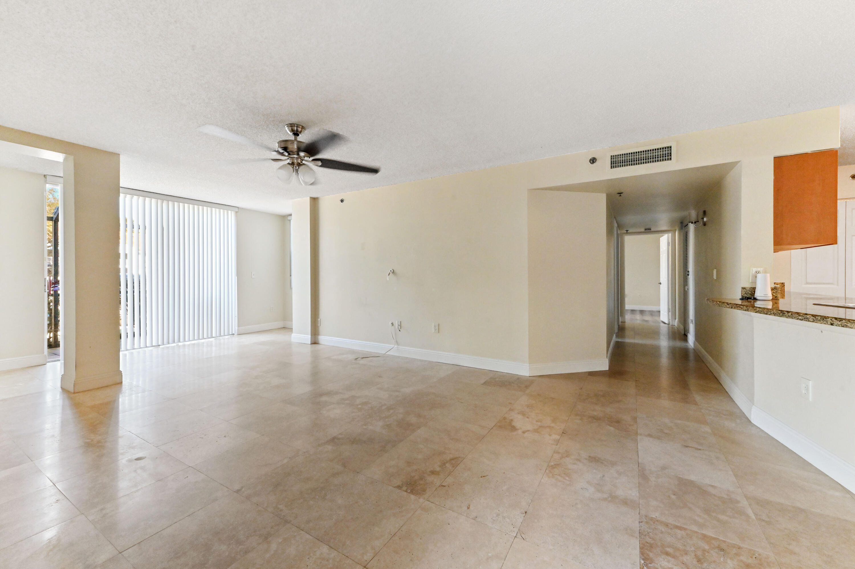 3237 Clint Moore Road, Unit 107 Boca Raton, FL 33496 - Photo 3 of 41 a view of an empty room with a kitchen