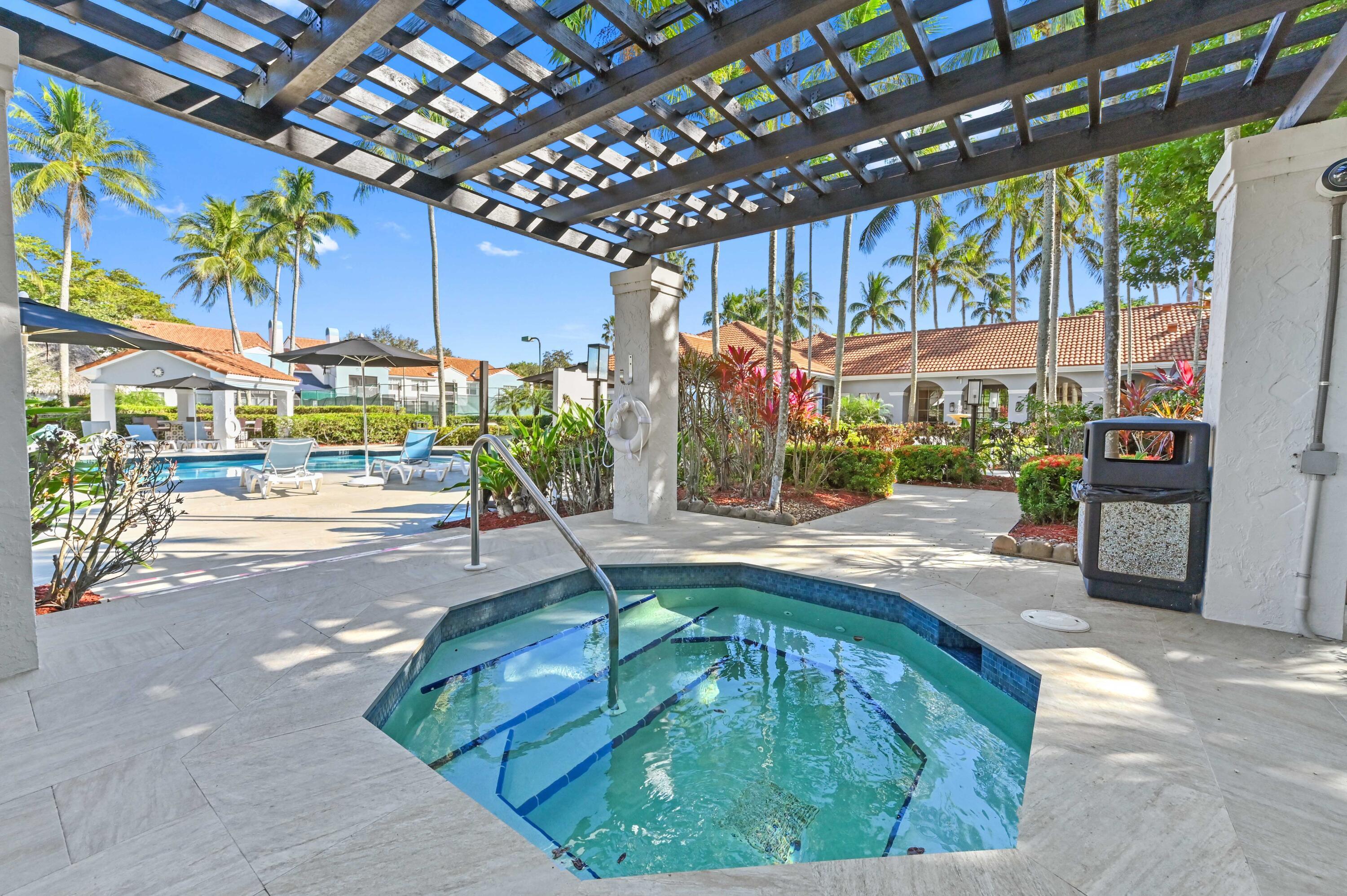 3237 Clint Moore Road, Unit 107 Boca Raton, FL 33496 - Photo 31 of 41 a swimming pool with yard