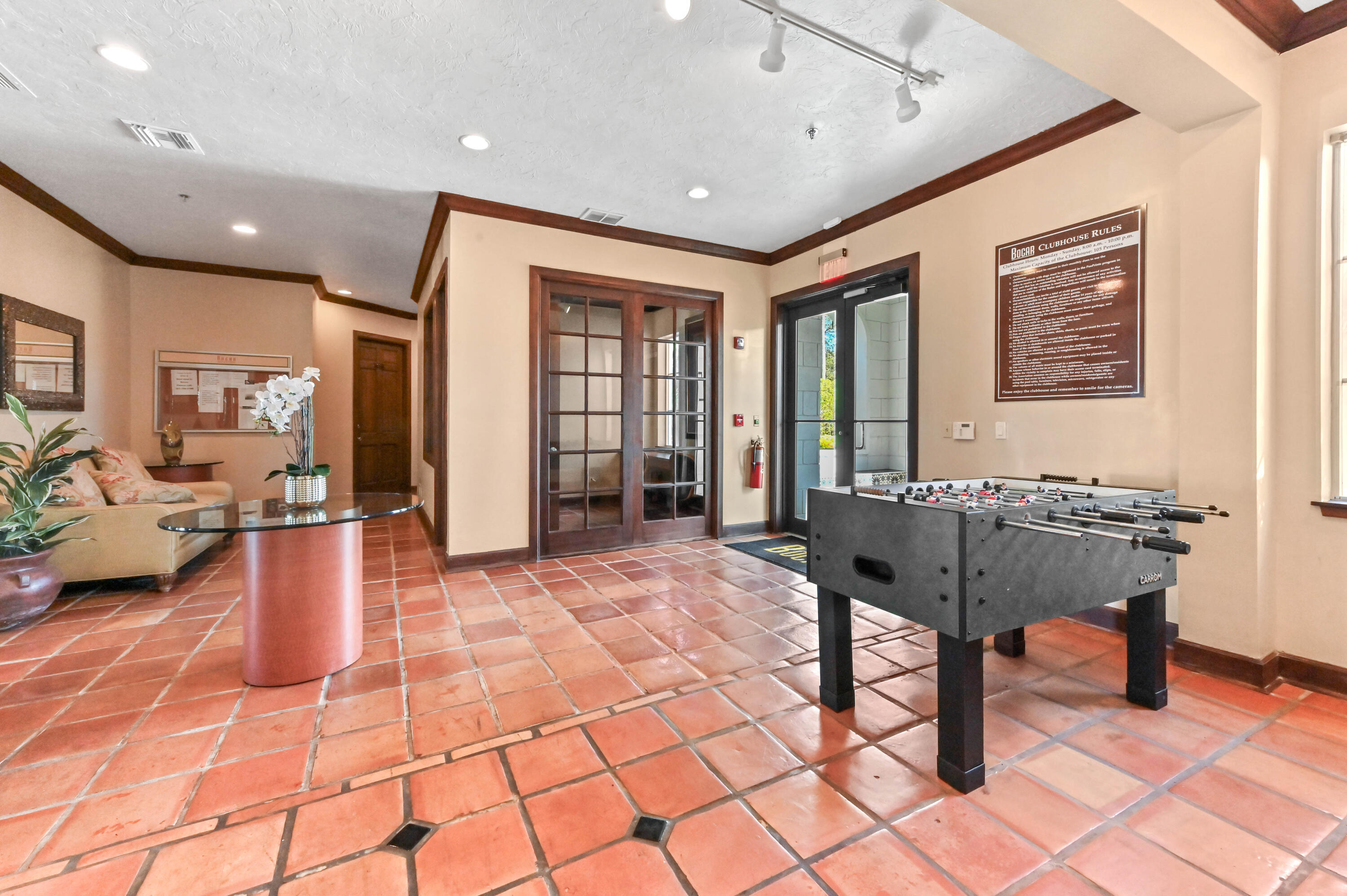 3237 Clint Moore Road, Unit 107 Boca Raton, FL 33496 - Photo 34 of 41 a living room with furniture a window and a table