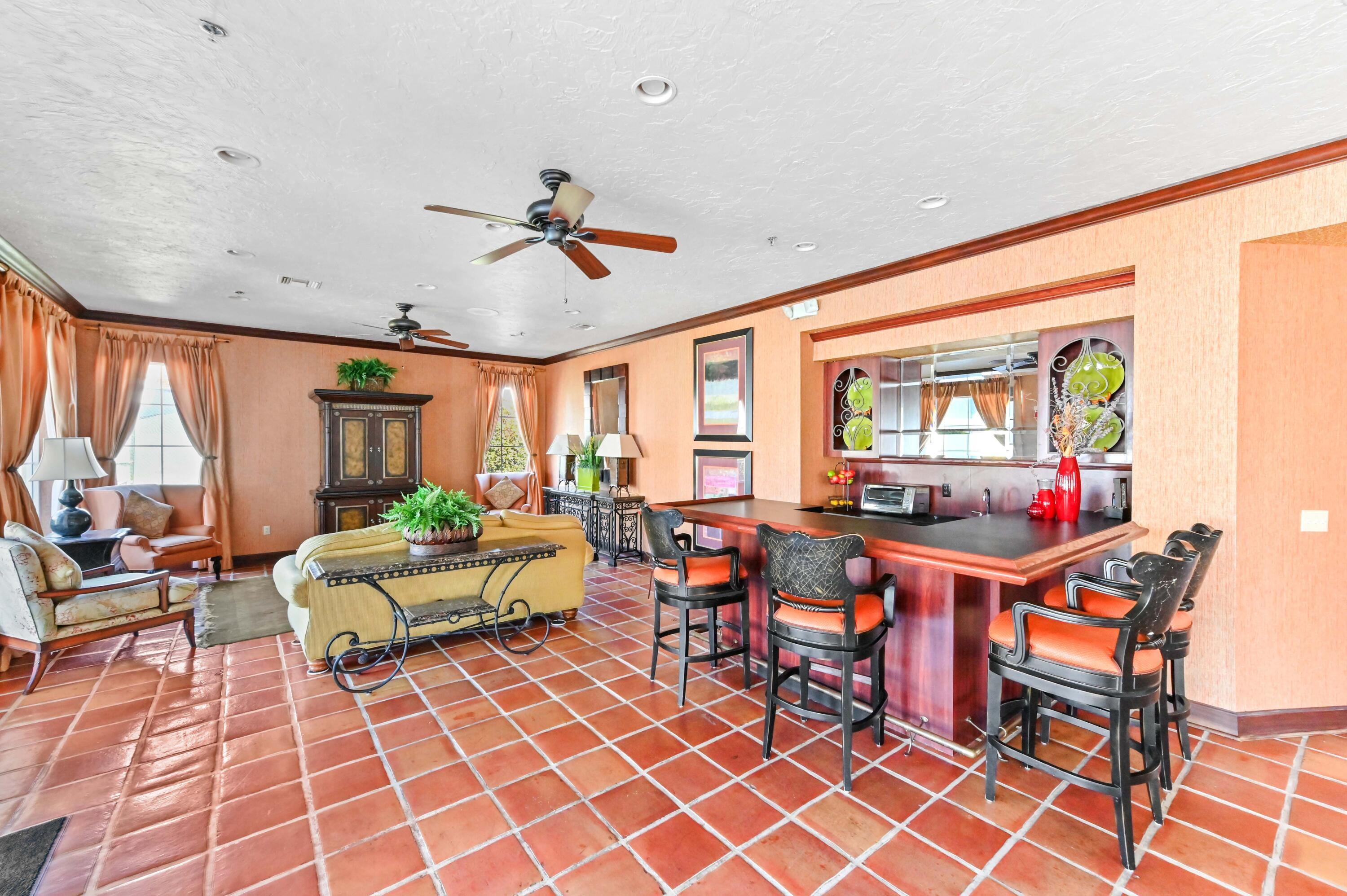 3237 Clint Moore Road, Unit 107 Boca Raton, FL 33496 - Photo 38 of 41 a living room with patio furniture and a large window