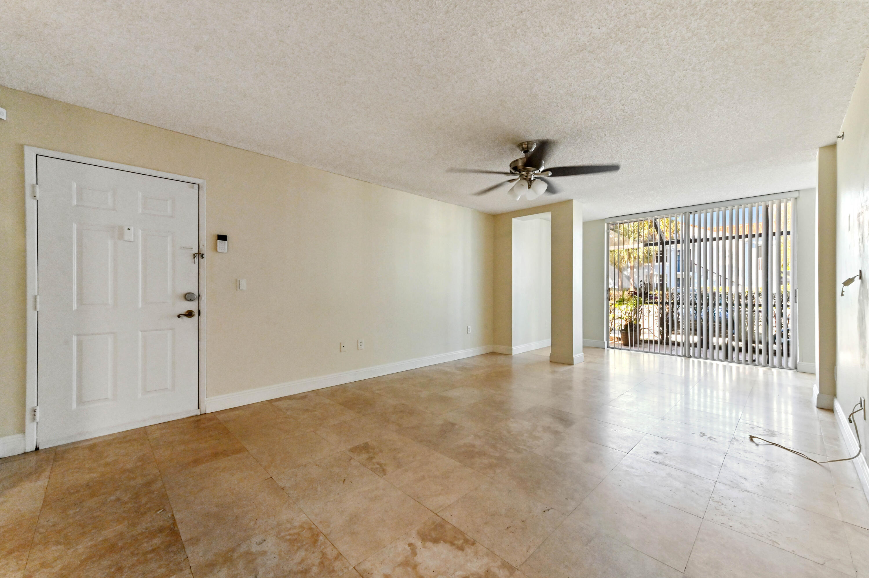 3237 Clint Moore Road, Unit 107 Boca Raton, FL 33496 - Photo 4 of 41 a view of a livingroom with a ceiling fan and window