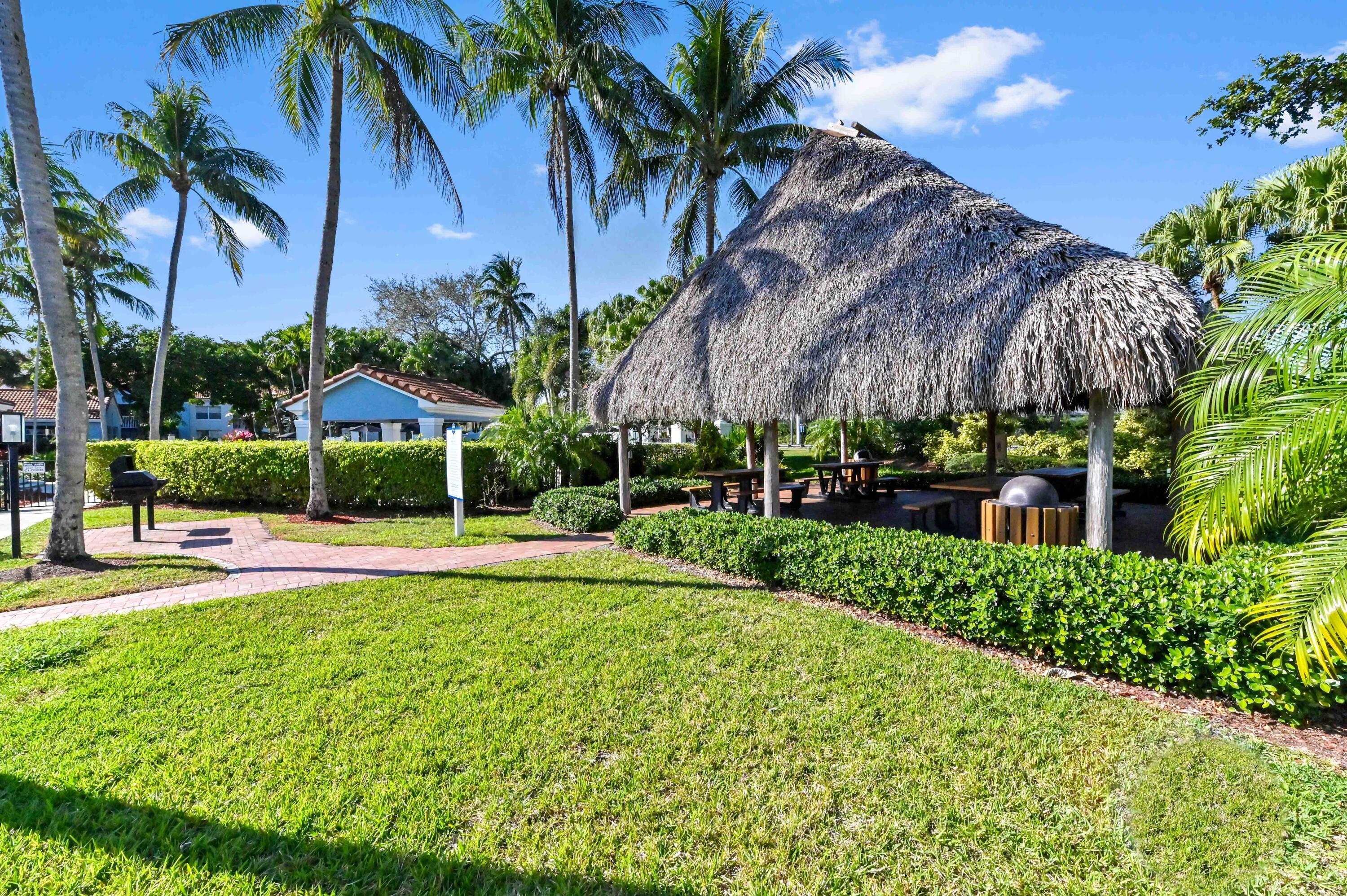 3237 Clint Moore Road, Unit 107 Boca Raton, FL 33496 - Photo 41 of 41 a view of a swimming pool with a garden