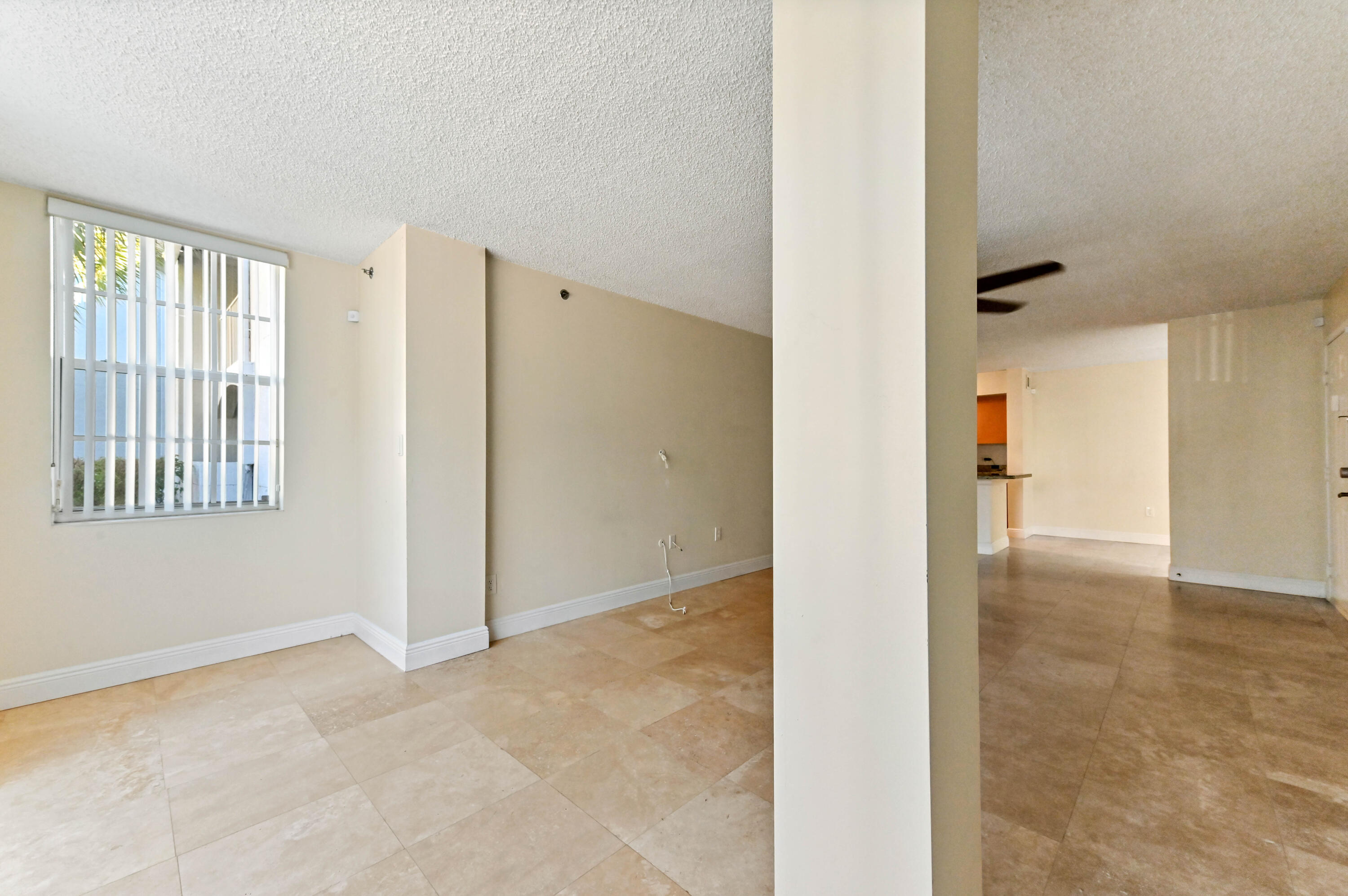 3237 Clint Moore Road, Unit 107 Boca Raton, FL 33496 - Photo 5 of 41 an empty room with windows and cabinet