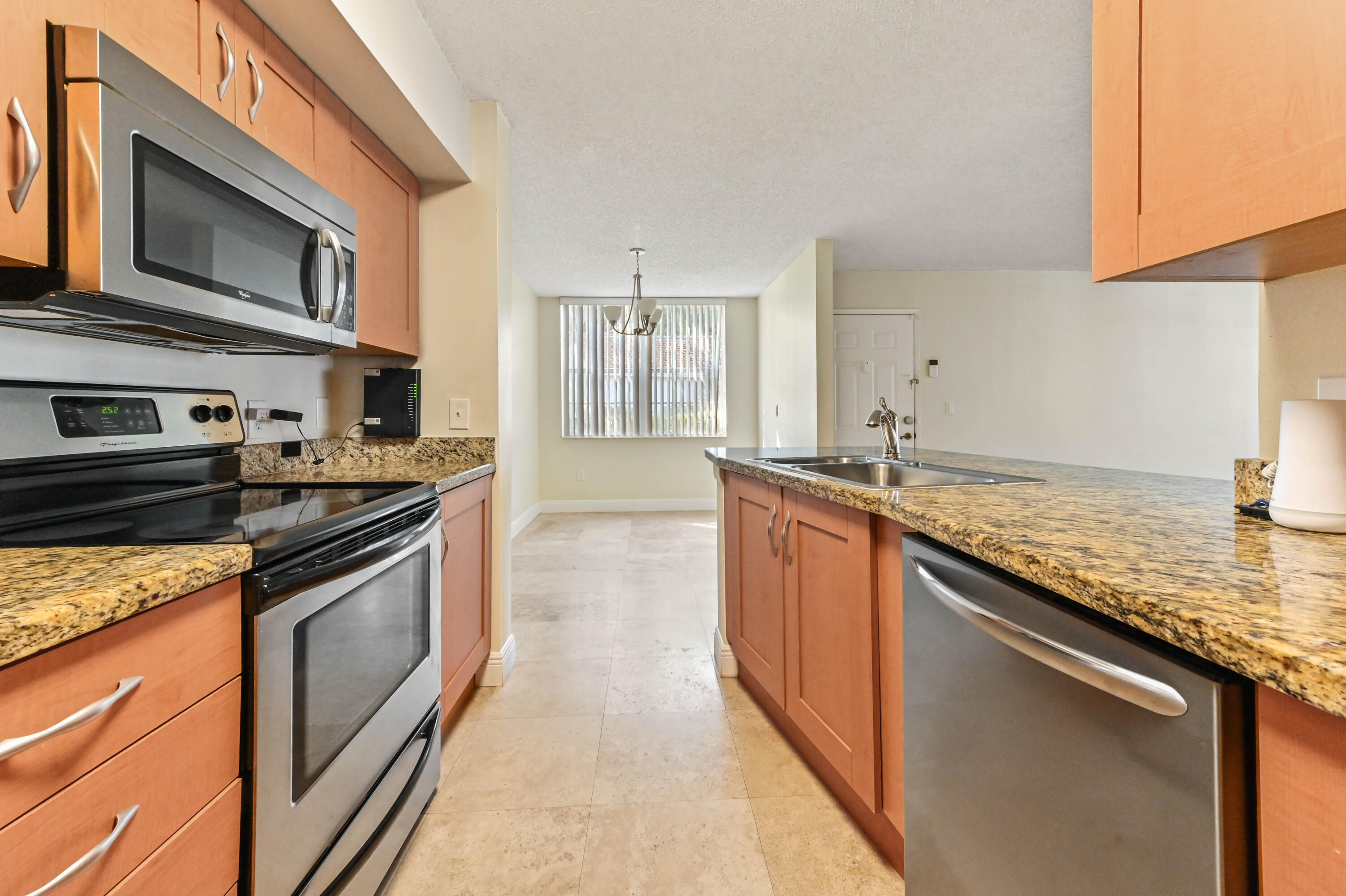 3237 Clint Moore Road, Unit 107 Boca Raton, FL 33496 - Photo 9 of 41 a kitchen with stainless steel appliances granite countertop a stove and a sink