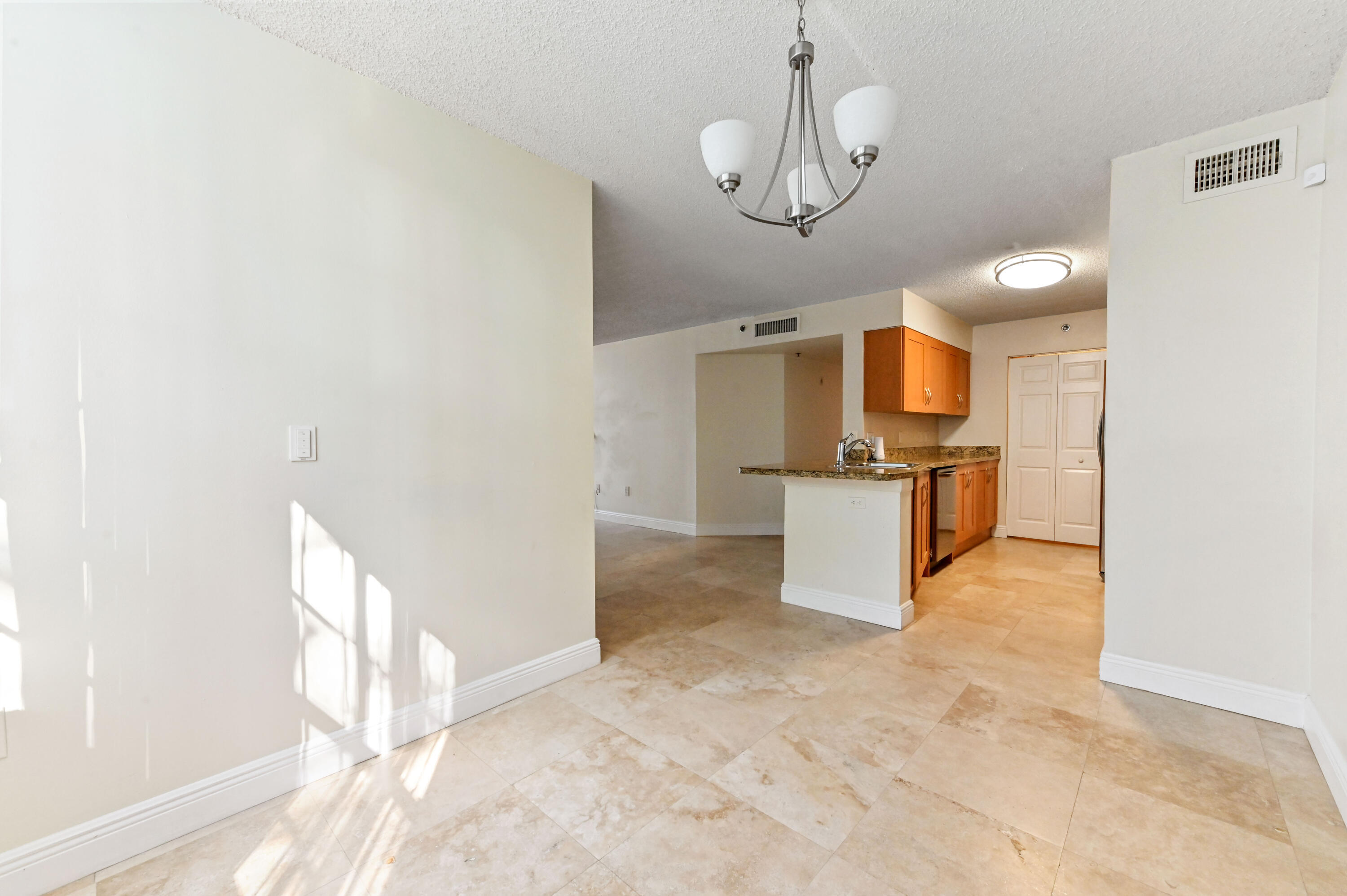 3237 Clint Moore Road, Unit 107 Boca Raton, FL 33496 - Photo 10 of 41 a view of a kitchen with a sink and dishwasher a refrigerator with wooden floor