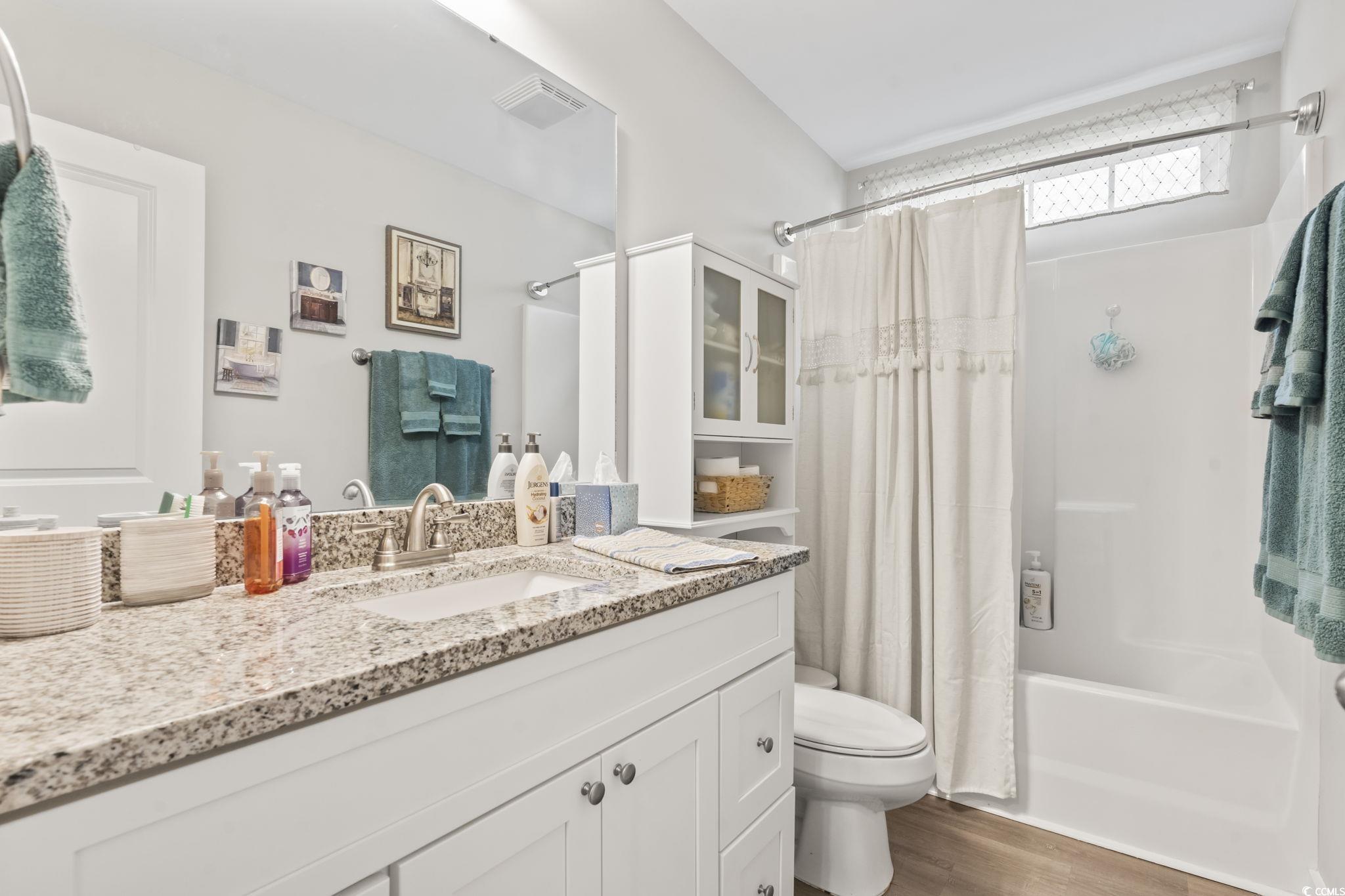 2715 Biscane Court Conway, SC 29527 - Photo 13 of 18 Bathroom with shower / bathtub combination with curtain, vanity, and light wood-type flooring
