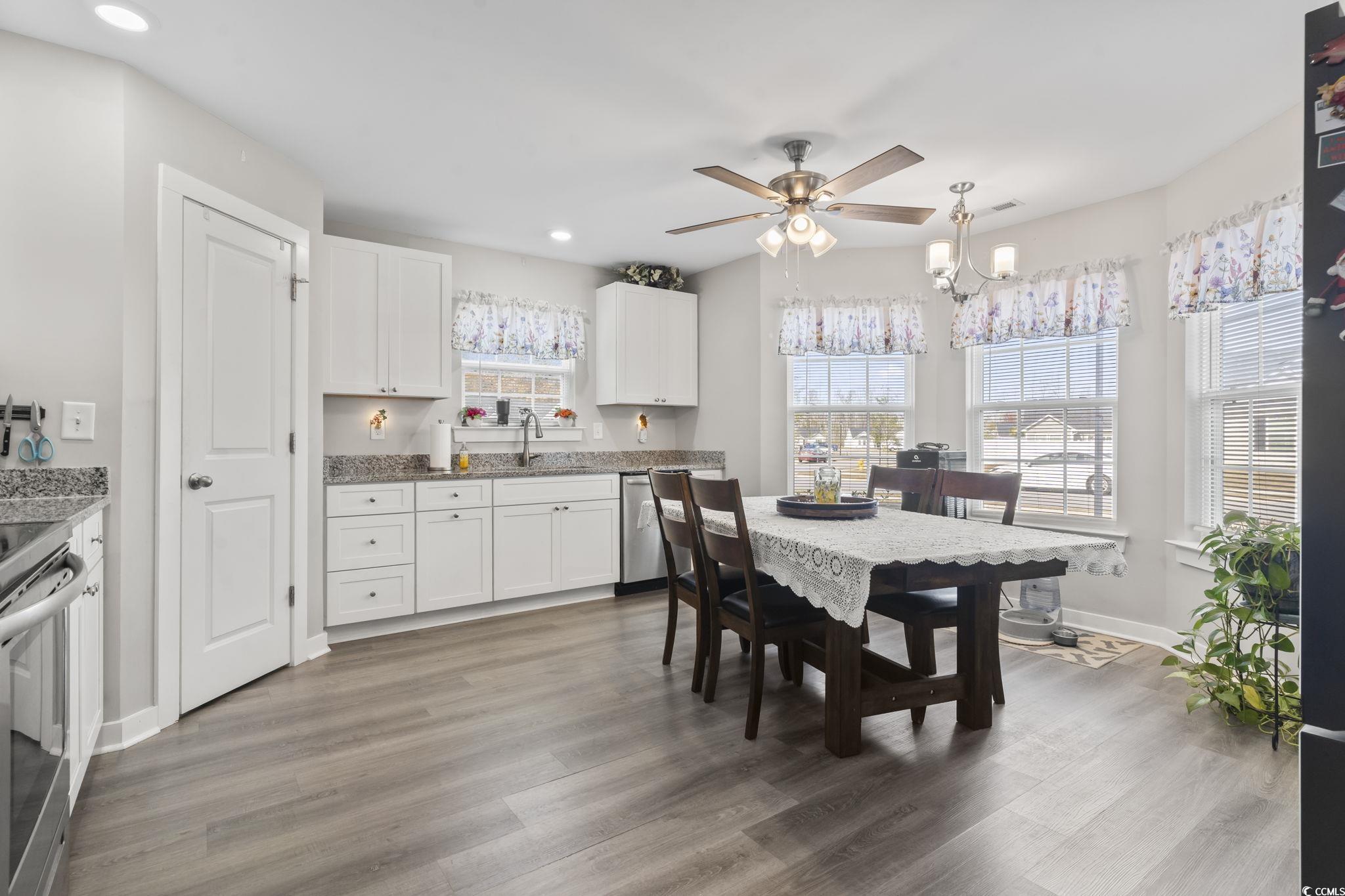 2715 Biscane Court Conway, SC 29527 - Photo 7 of 18 Kitchen with white cabinetry, light stone counters, appliances with stainless steel finishes, hanging light fixtures, and recessed lighting