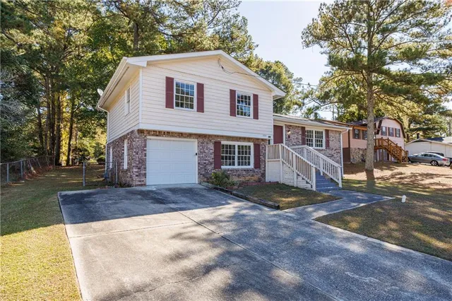 a front view of a house with a yard