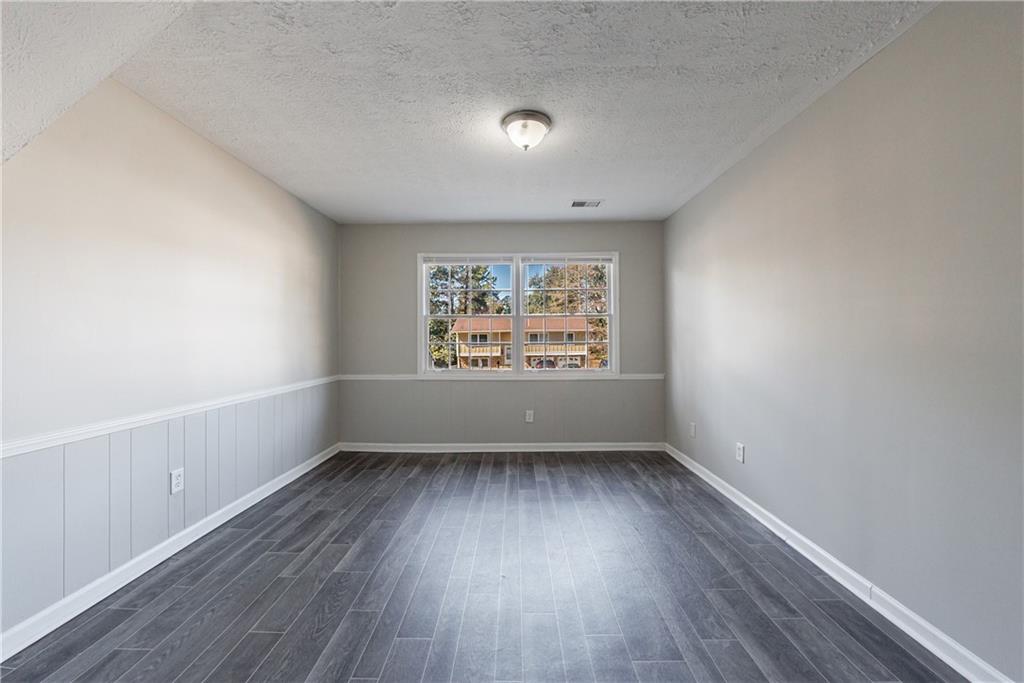 5755 Bearing Way Atlanta, GA 30349 - Photo 17 of 31 an empty room with wooden floor and windows