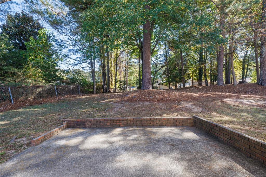 5755 Bearing Way Atlanta, GA 30349 - Photo 20 of 31 a view of a yard with large trees
