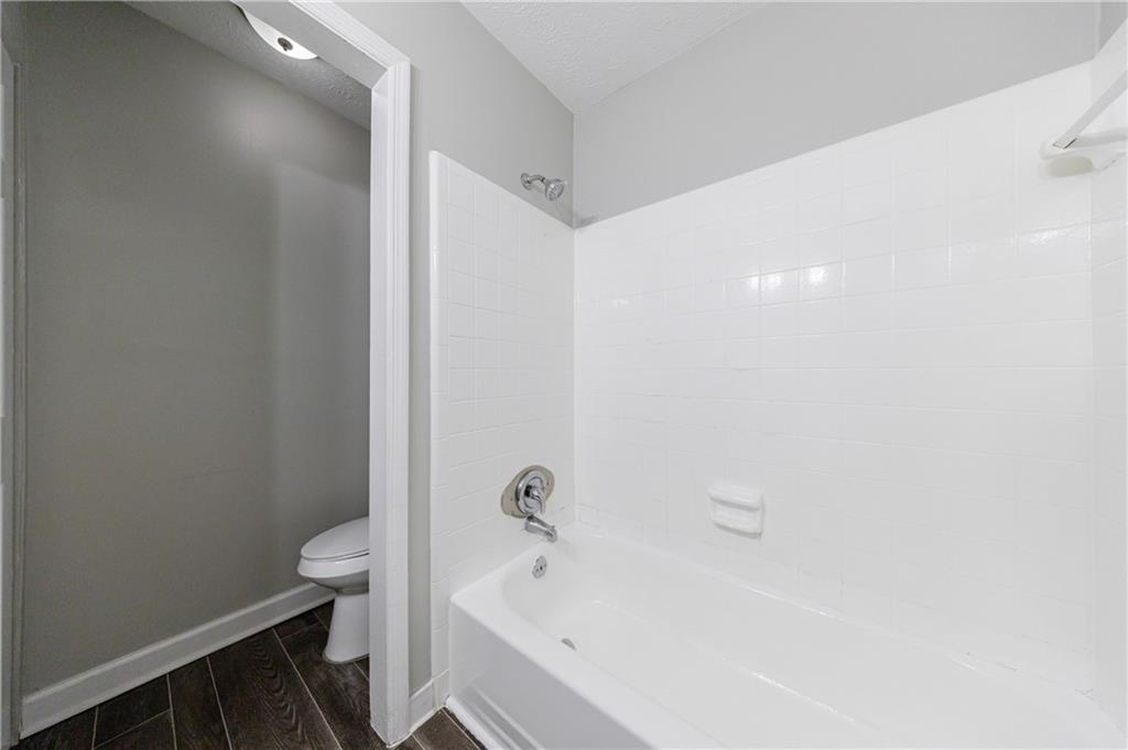 5755 Bearing Way Atlanta, GA 30349 - Photo 27 of 31 a bathroom with a bathtub and toilet