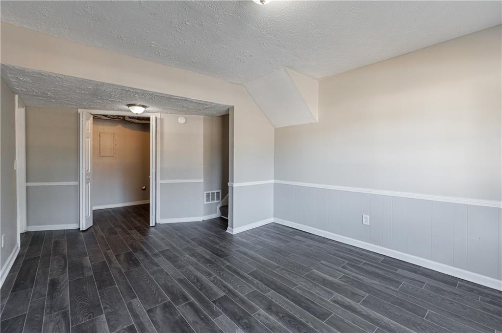 5755 Bearing Way Atlanta, GA 30349 - Photo 30 of 31 a view of an empty room with wooden floor and closet