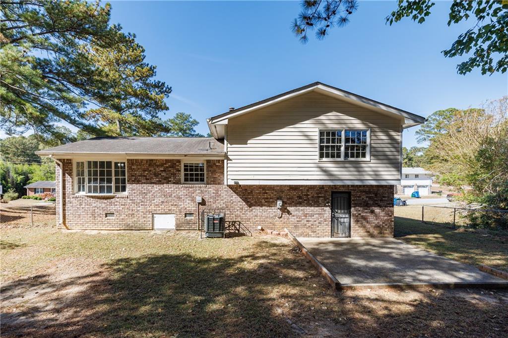5755 Bearing Way Atlanta, GA 30349 - Photo 3 of 31 a front view of a house with a yard