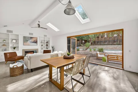 a view of a dining room with furniture wooden floor and a rug